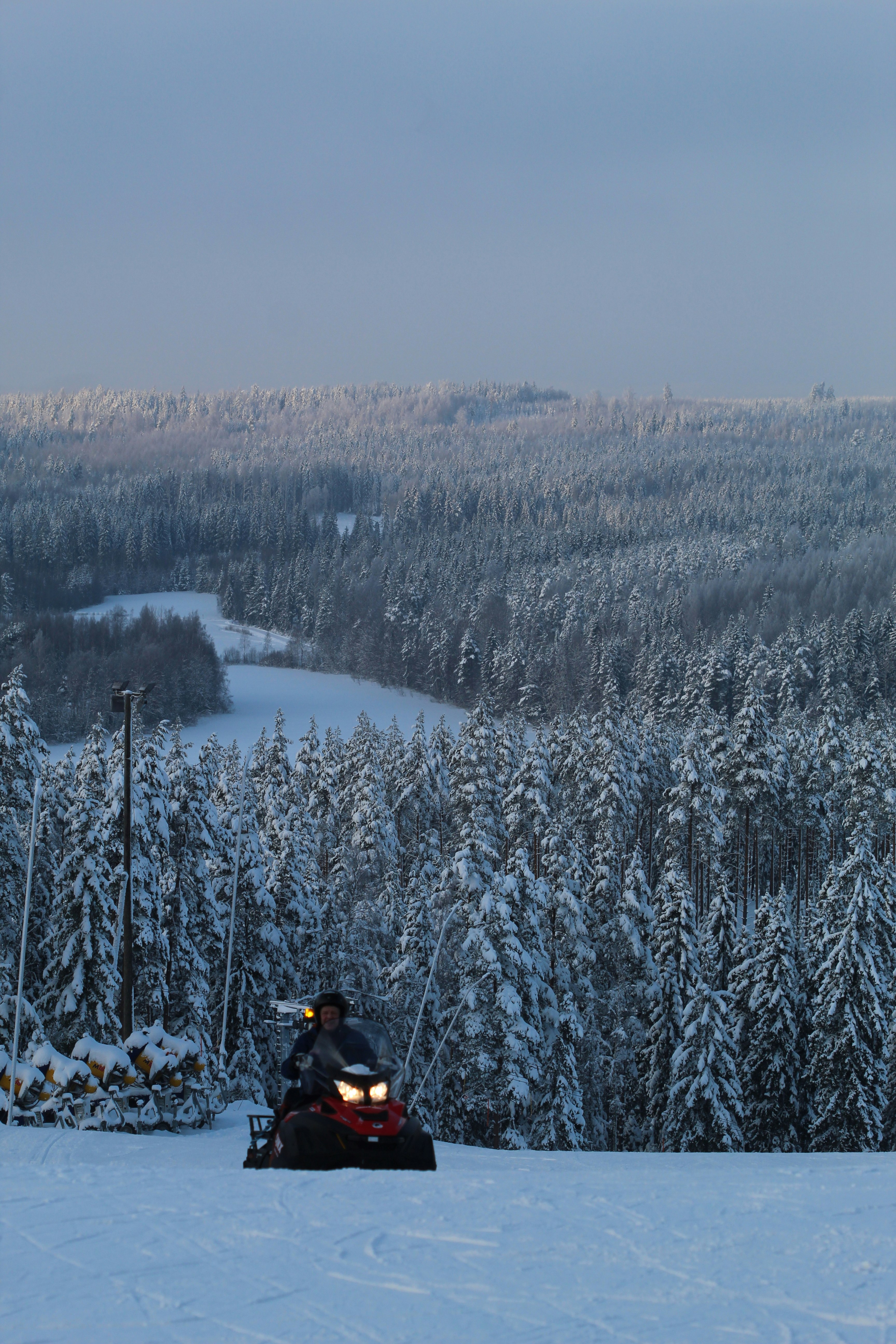 person in black jacket sitting on snow covered ground during daytime